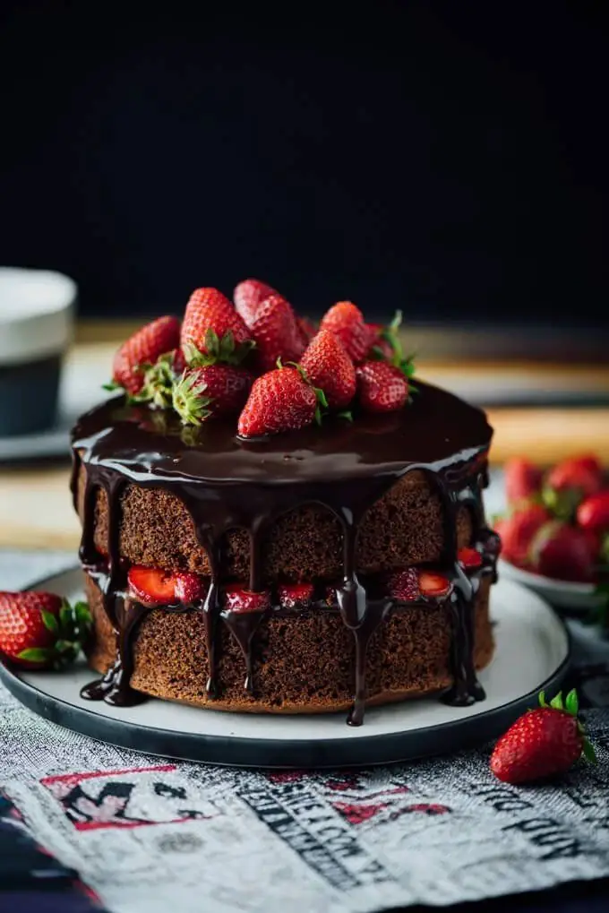 A chocolate layer cake topped with strawberries