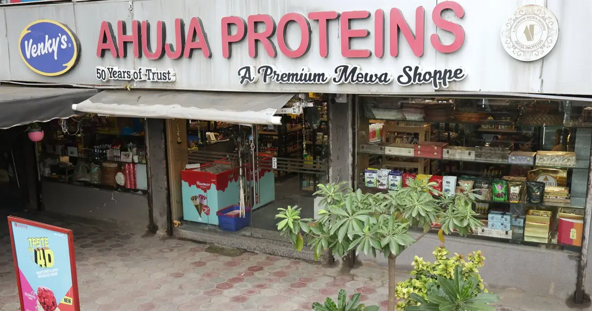 The Ahuja Proteins shopfront in Bhopal, its sign reading 50 Years of Trust, A Premium Mewa Shoppe
