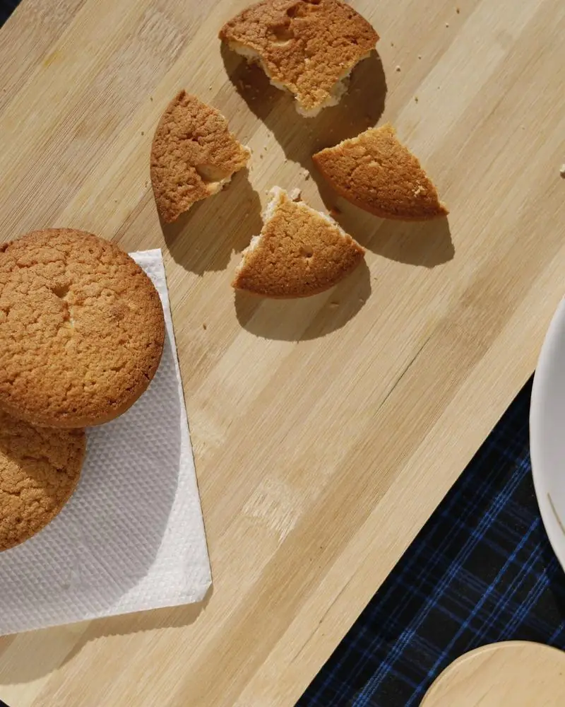 Homemade cookies on a wooden board, one broken open