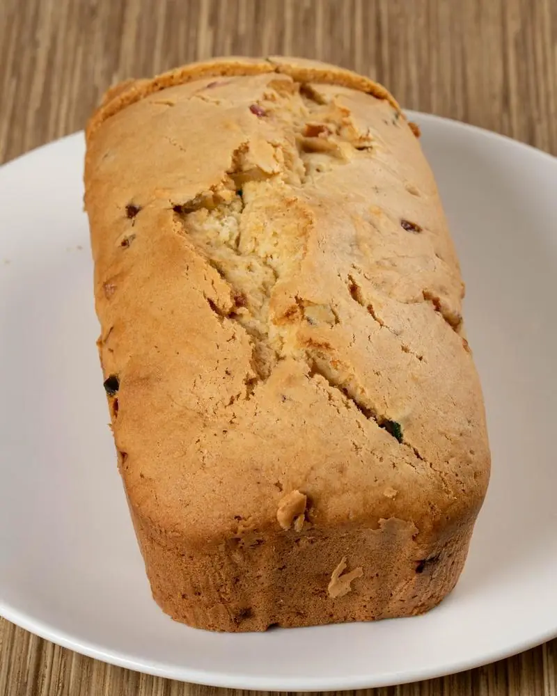A baked fruit loaf on a white plate