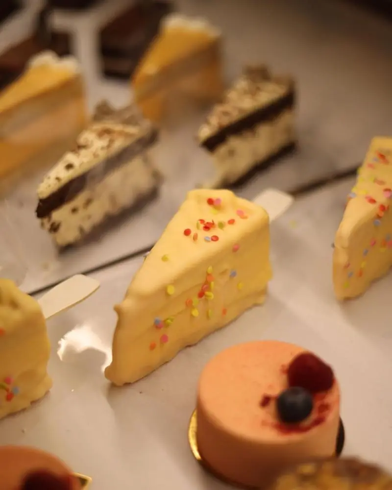 Assorted iced pastry slices on a bakery tray