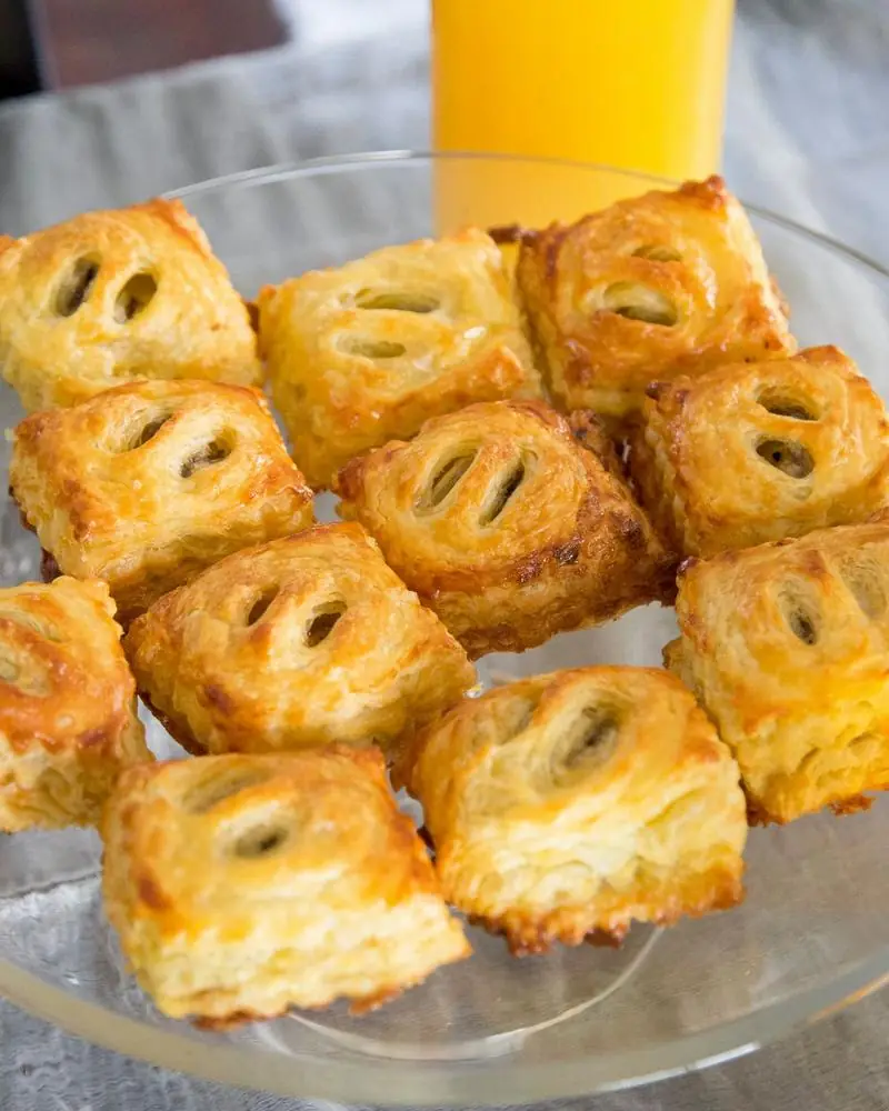 Square puff-pastry patties with slit tops, freshly baked